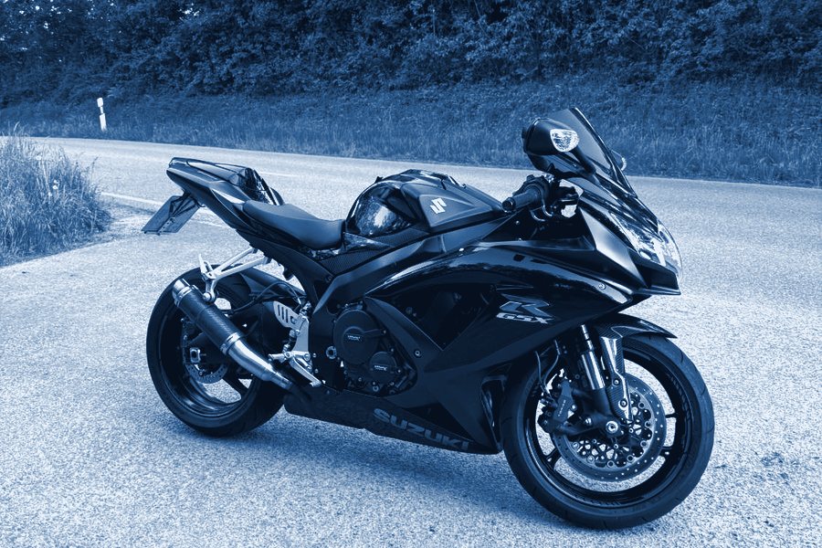Black Suzuki GSX-R sports motorcycle on a country road