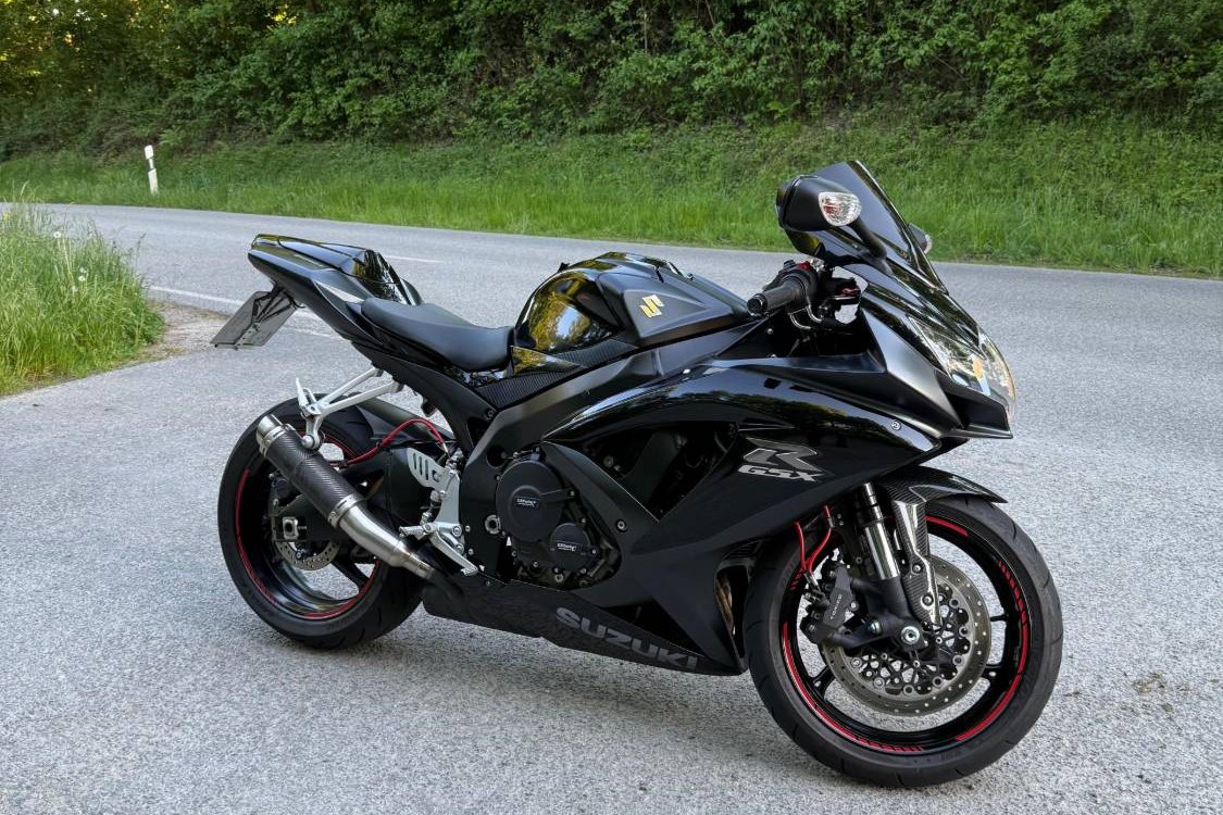Black Suzuki GSX-R sports motorcycle on a country road